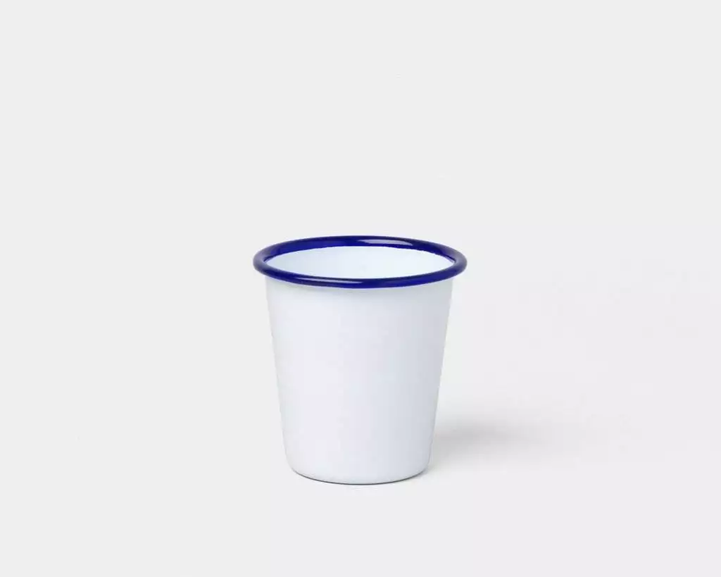 A white Falcon Enamelware cup on a white surface.